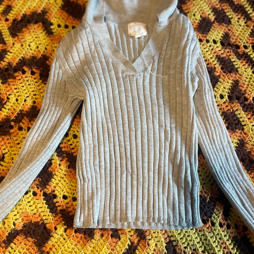 This is a cropped gray shirt with a collar.